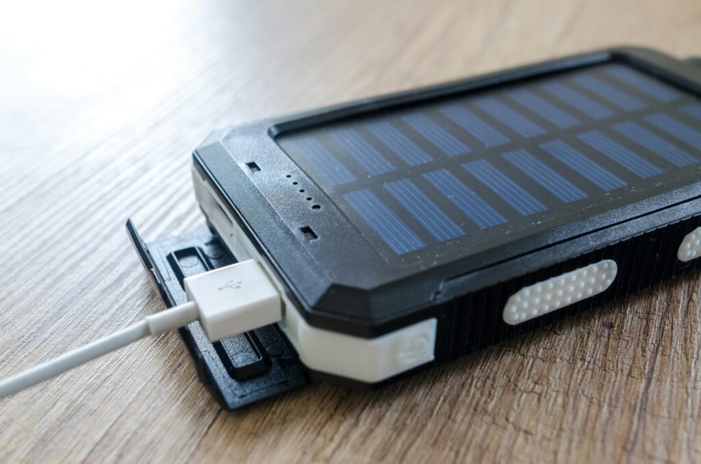 pexels-photo-518530-518530 A close-up of a solar charger with a USB connection on a wooden surface, showcasing modern technology.